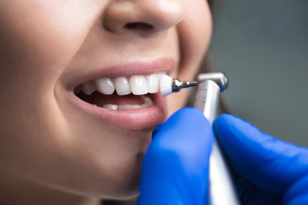 Young woman having a dental cleaning performed on her teeth