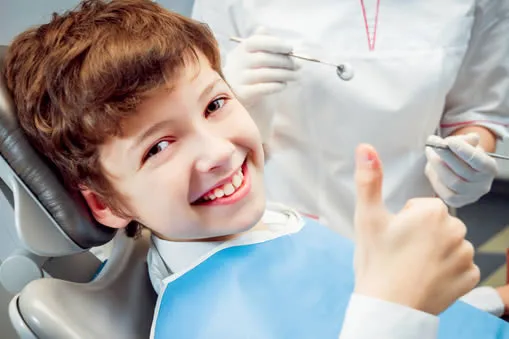 Young boy smiling at the dentist during a pediatric dental visit