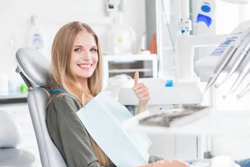 Young woman at dentist receiving dental exam