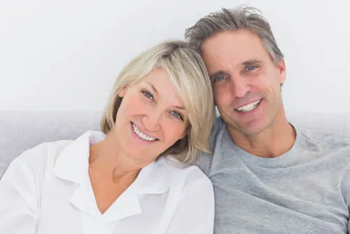 Smiling couple — dental implant special